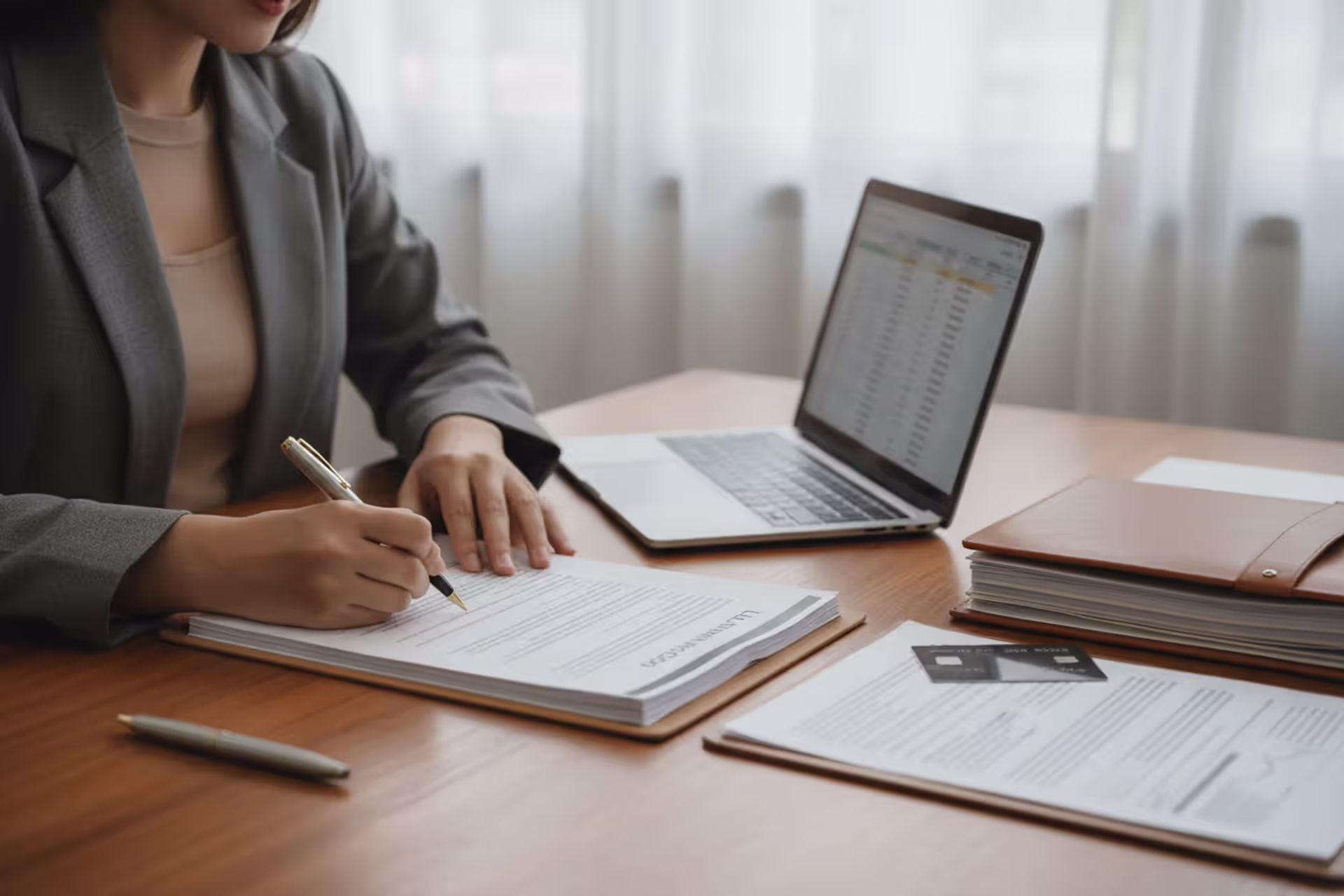 Business owner reviewing LLC capital contribution documents in an office
