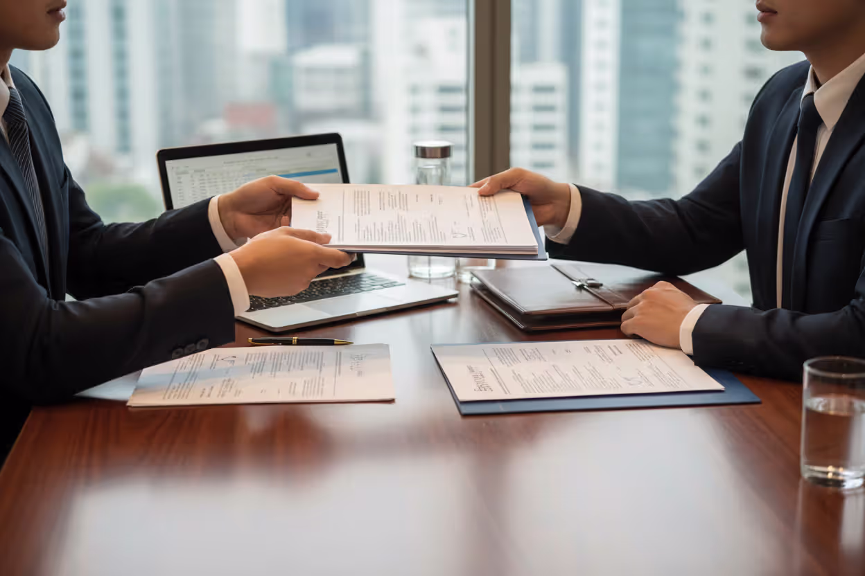 Business partners reviewing LLC member withdrawal documents